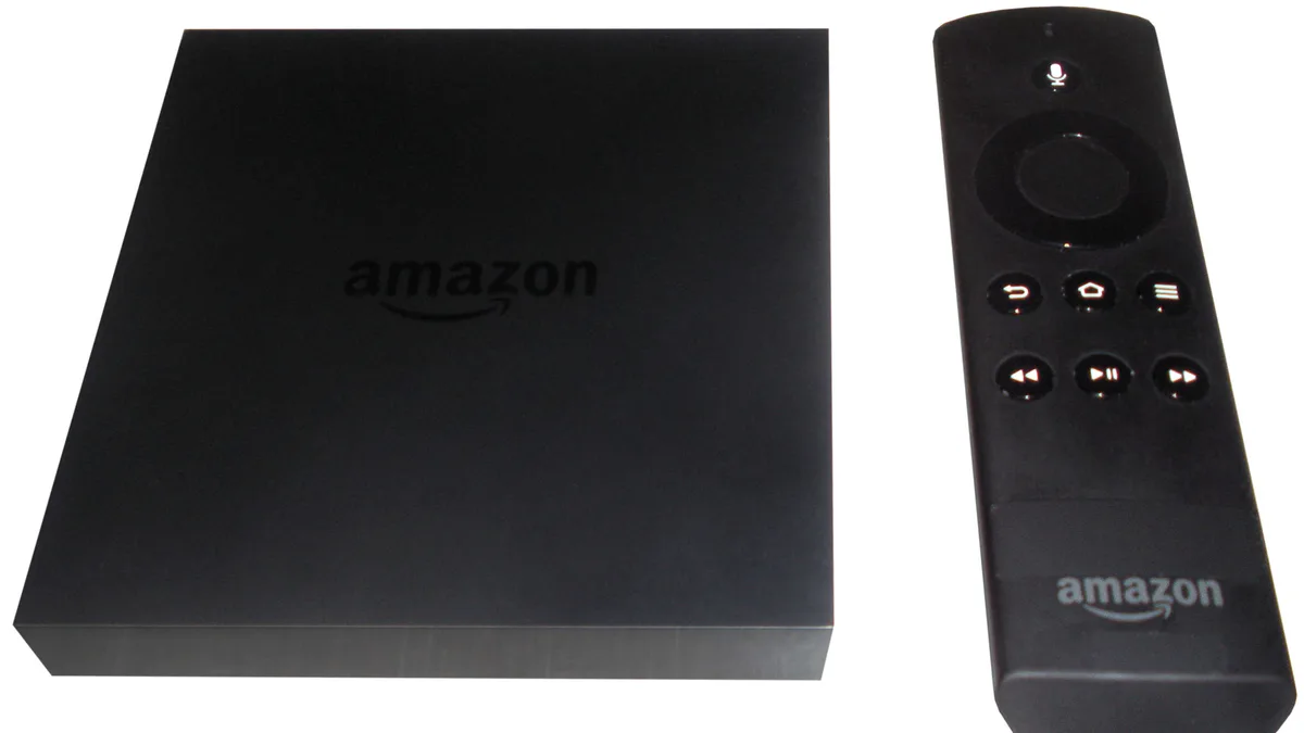 Amazon Fire TV Stick with its remote control