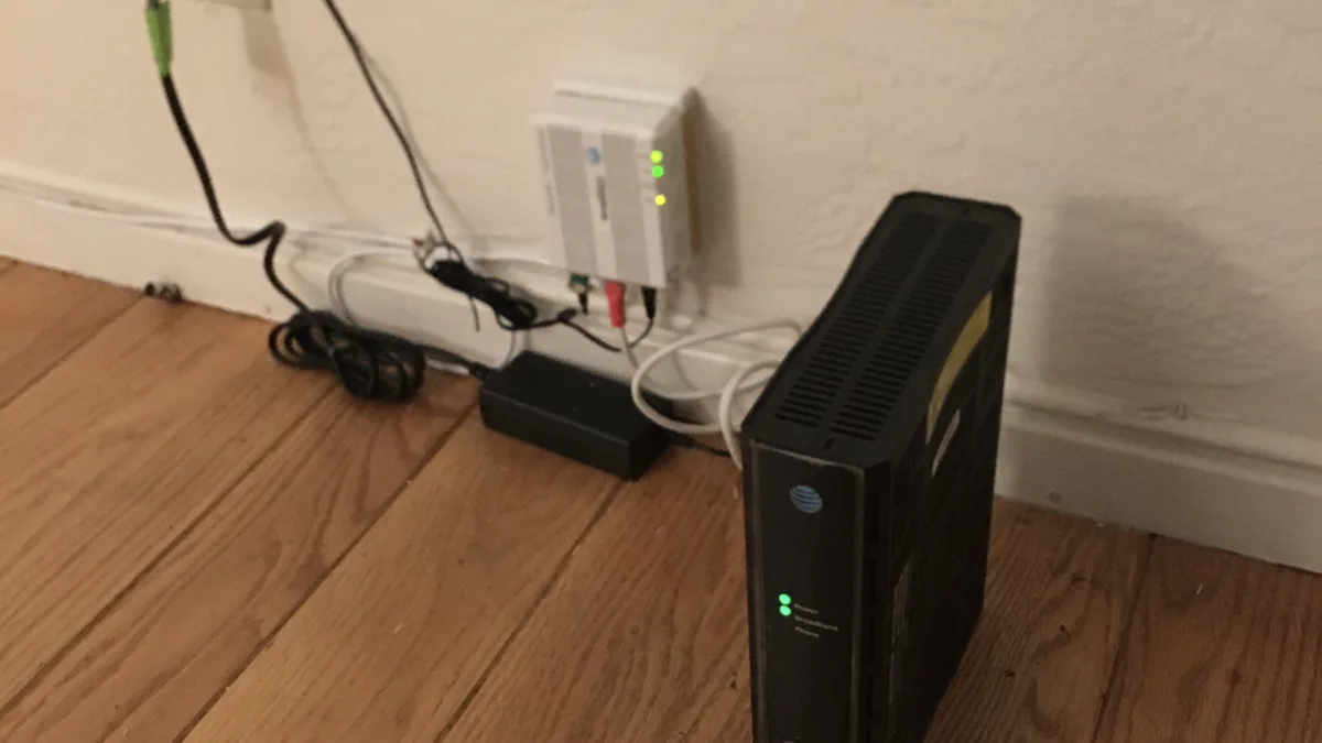 Photo by Mrbeastmodeallday, licensed under CC BY-SA 4.0 (Wikimedia Commons) Home Wi-Fi router and modem on a shelf, a common source of IPTV buffering and freezing issues