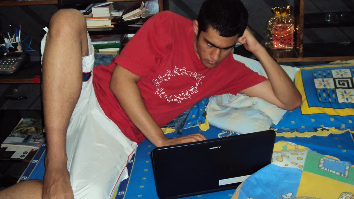 Person using a laptop to review a setup checklist